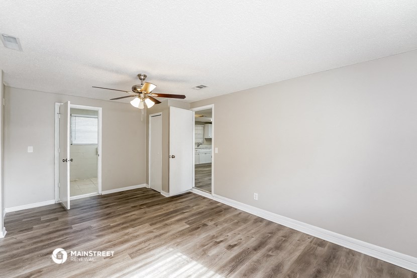 the living room of our two bedroom apartment atrium with a ceiling fan