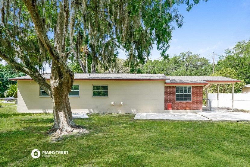 a home with a tree in front of it