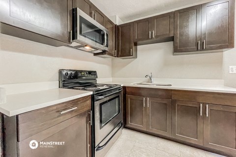 a kitchen with stainless steel appliances and wooden cabinets