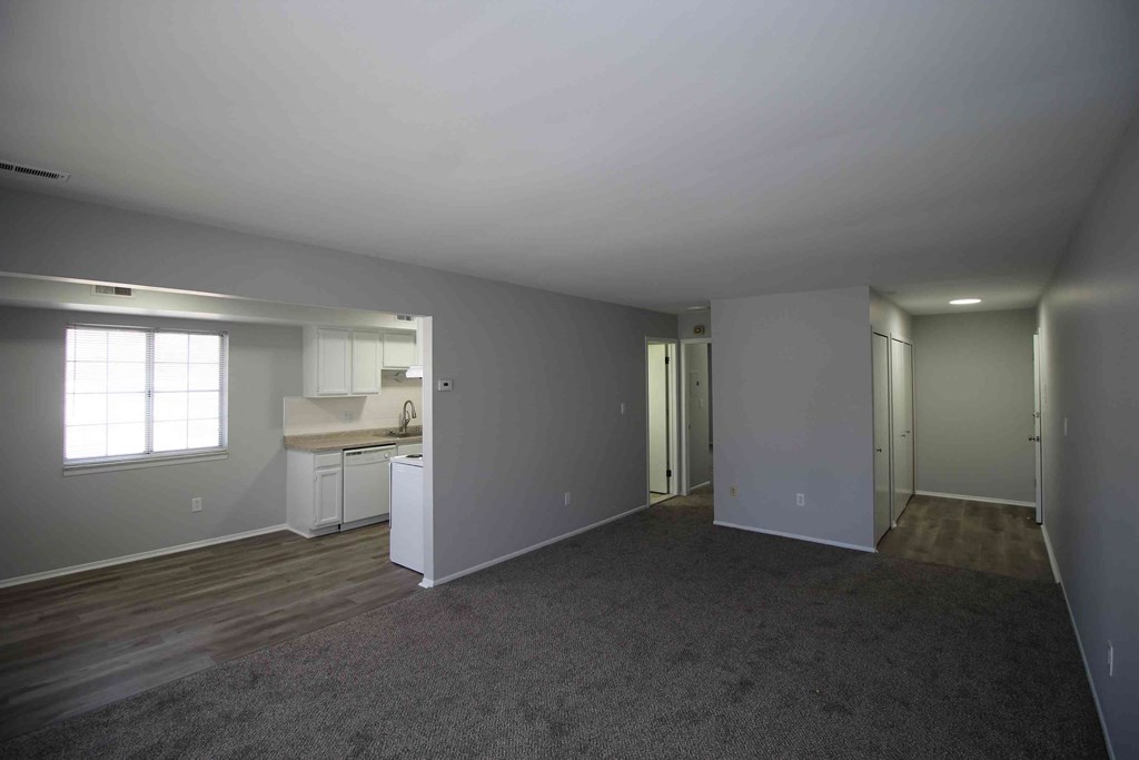 an empty living room and kitchen in a house