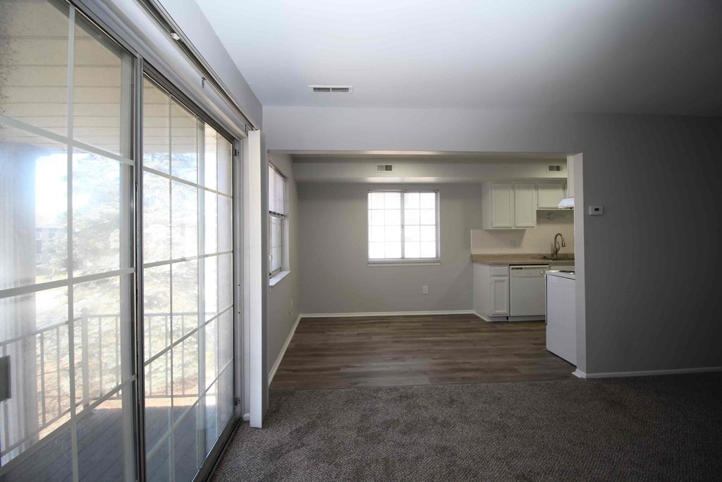 a view of a living room and kitchen from a balcony