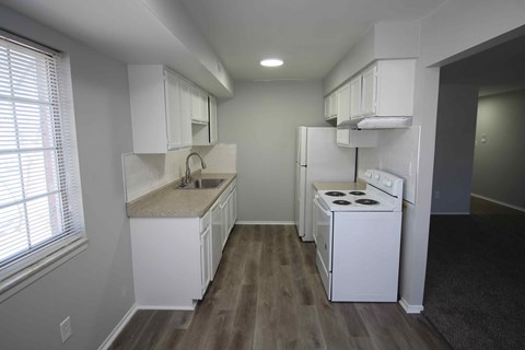 a kitchen with white appliances and white cabinets