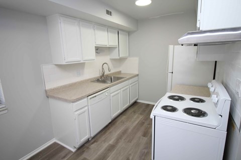 a kitchen with white cabinets and a stove and refrigerator