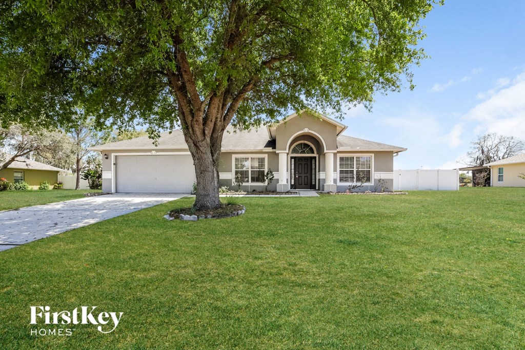 A large house with a tree in front of it.
