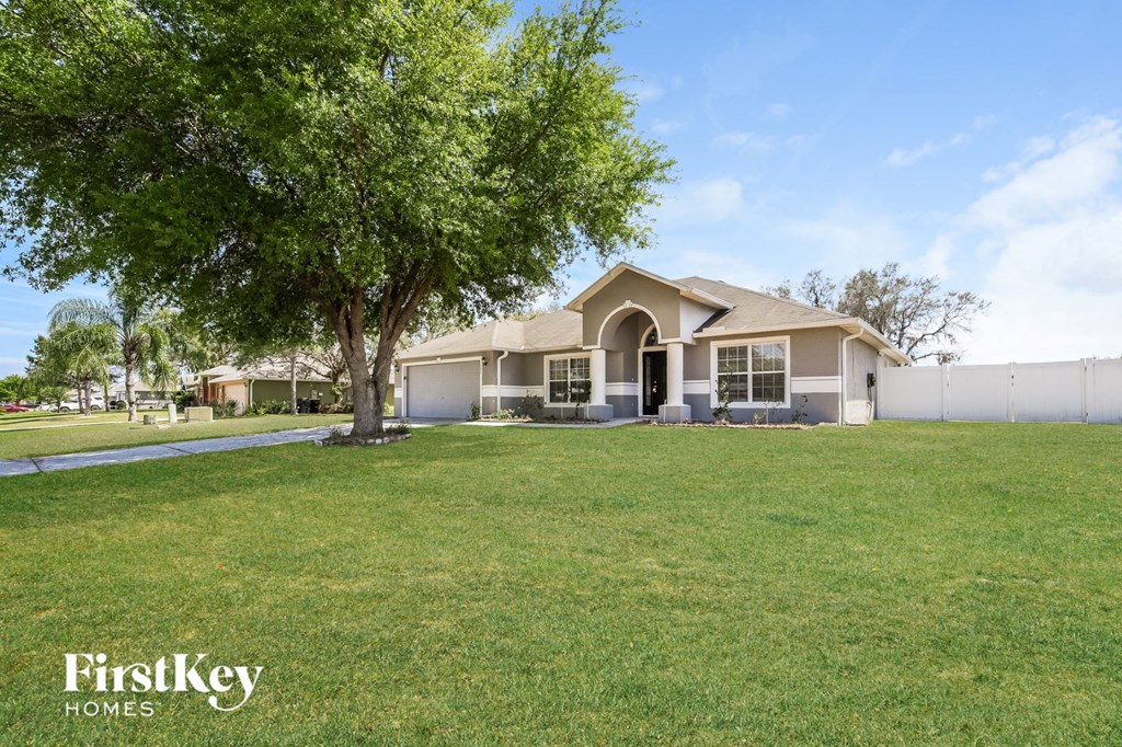 A house with a tree in front of it and the words "FirstKey Homes" on the bottom.