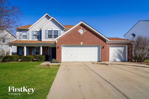 a large brick house with a white garage door