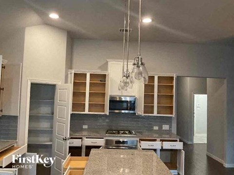 a kitchen with stainless steel appliances and white cabinets