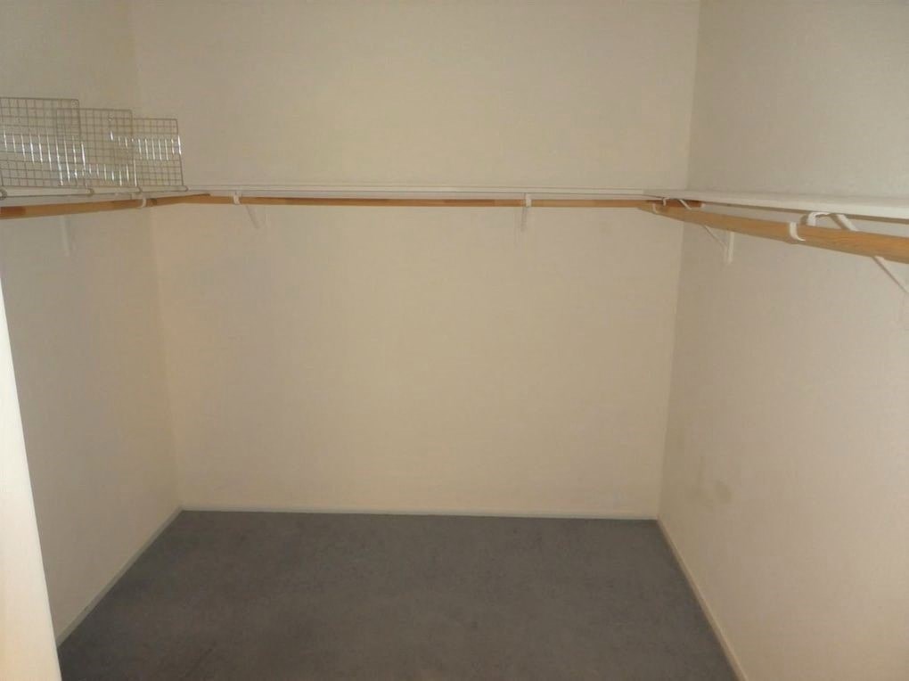 A room with a grey carpet and white walls.