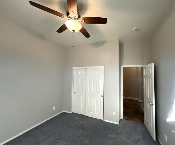 A room with a ceiling fan and two doors.
