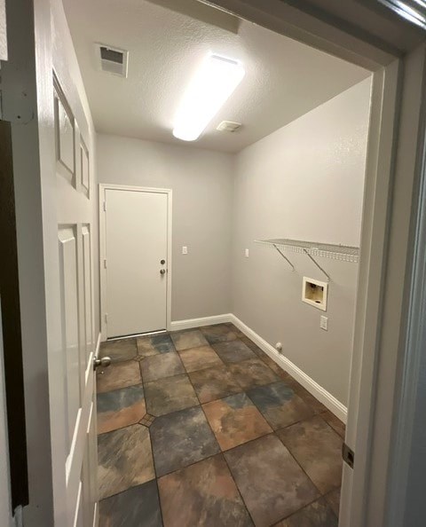 A hallway with a tiled floor and white walls.