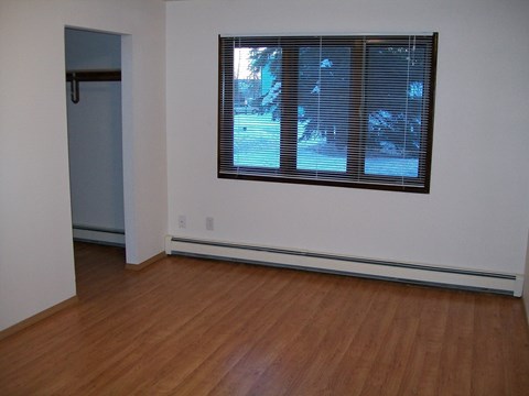 A room with a window and a door.