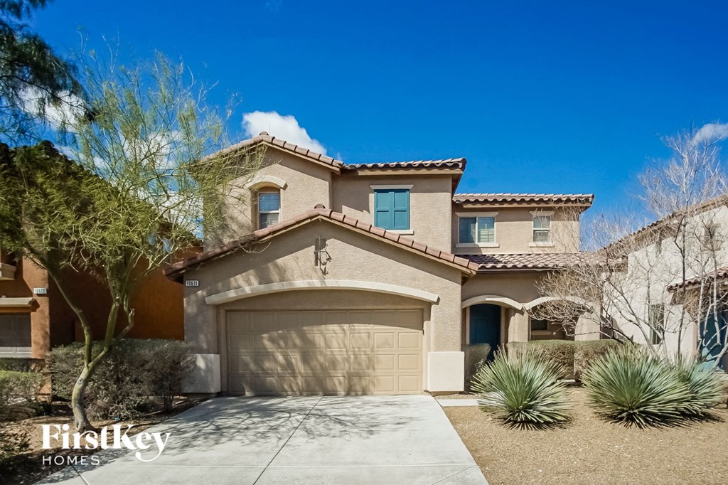 a house with a garage and a driveway in front of it