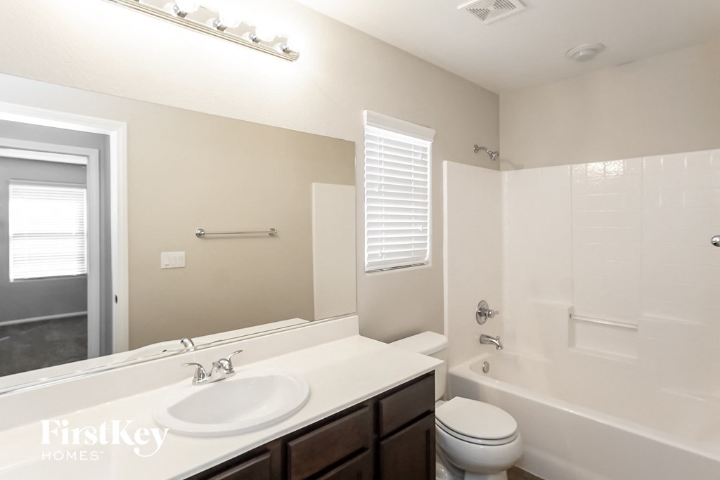 a bathroom with a sink and a toilet and a shower