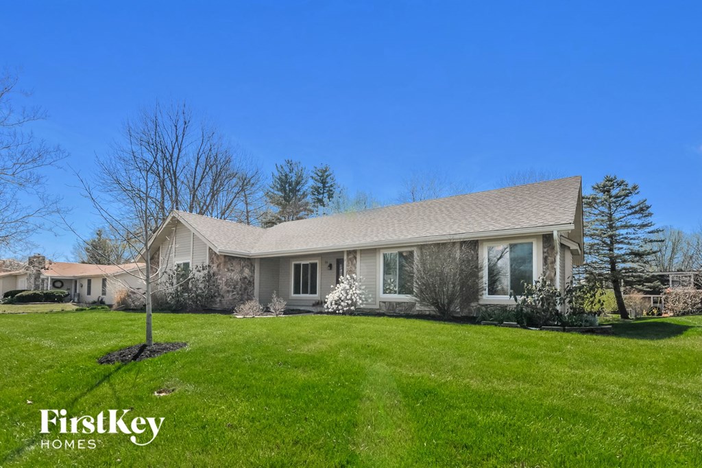 A house with a lawn in front of it.
