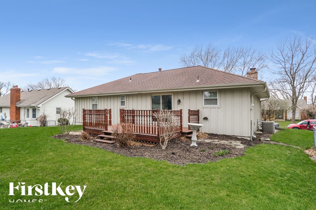 a backyard with a deck and a house