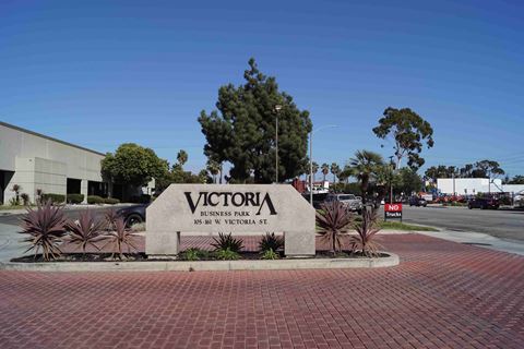 the sign for victory business park in front of a parking lot
