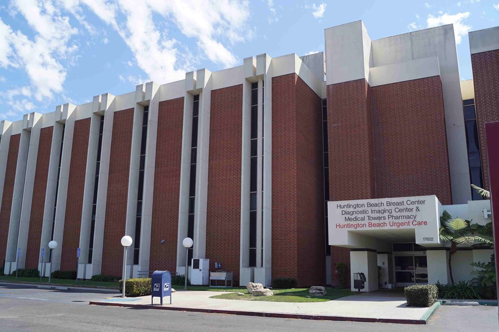 a large brick building with a sign in front of it