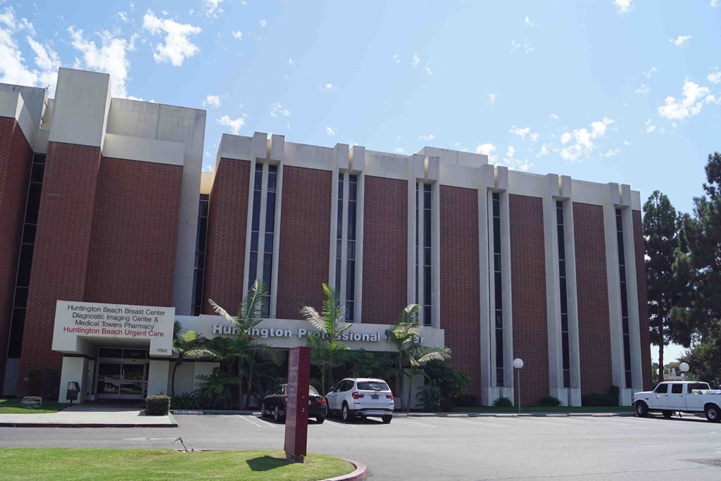 a large brick building with cars parked in front of it
