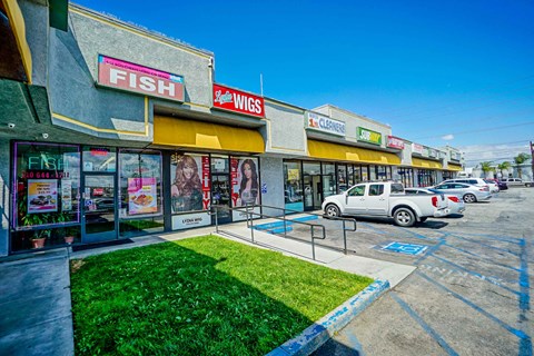a fish store with cars parked in front of it