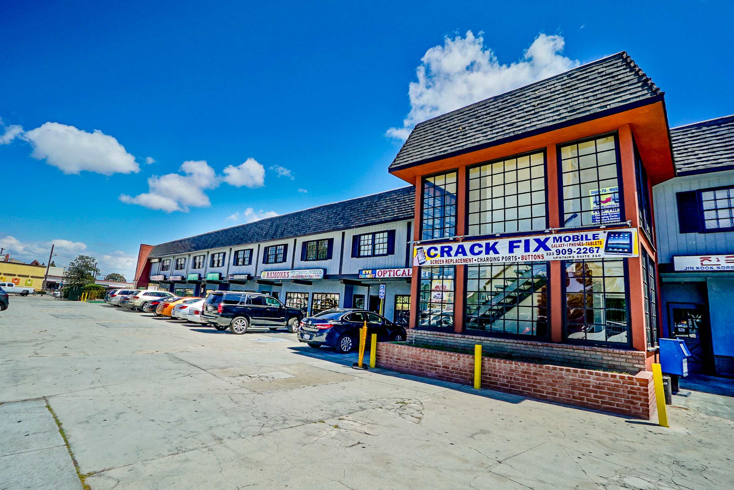 the front of the crack fix building with cars parked outside