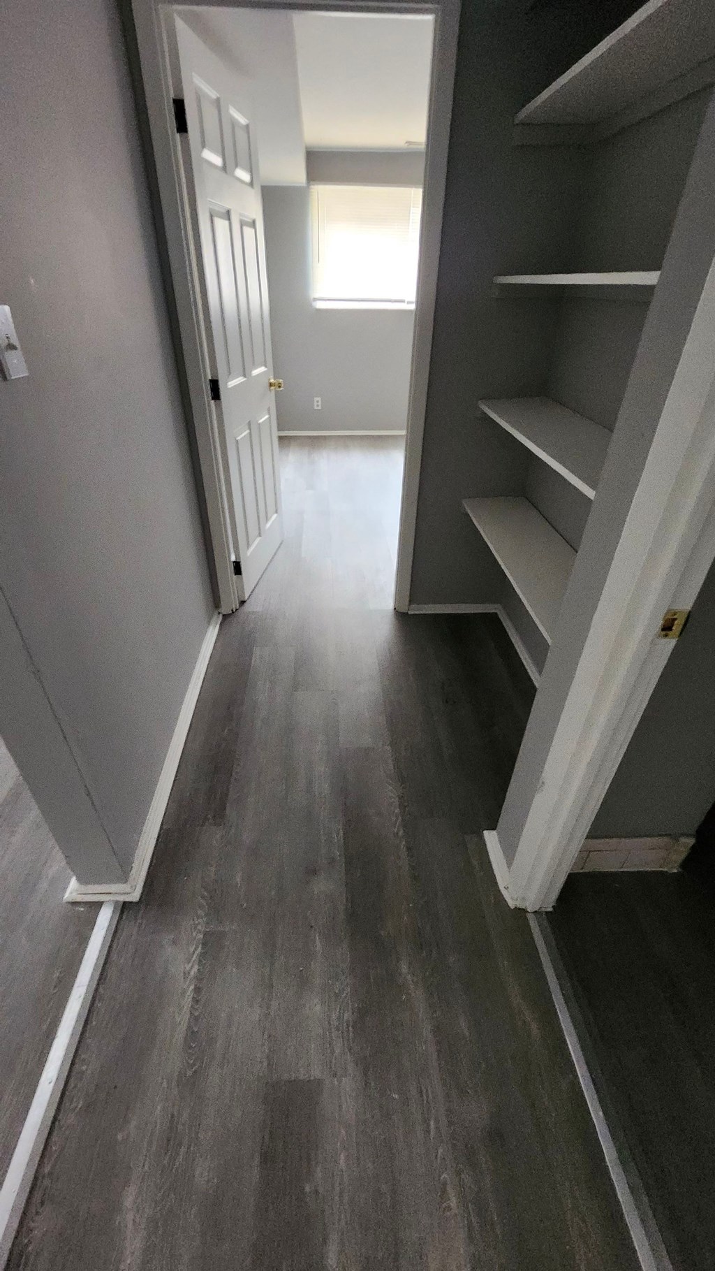 A hallway with a staircase on the right.