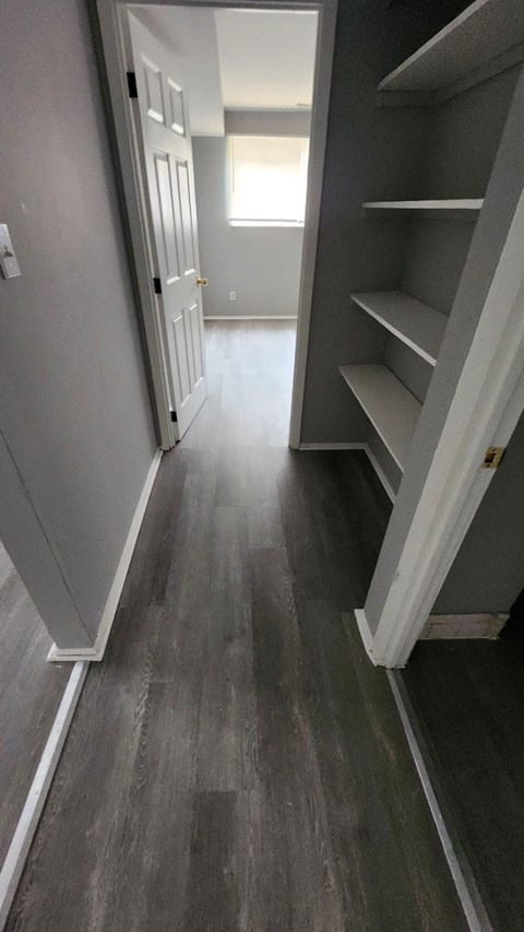 A hallway with a staircase on the right.