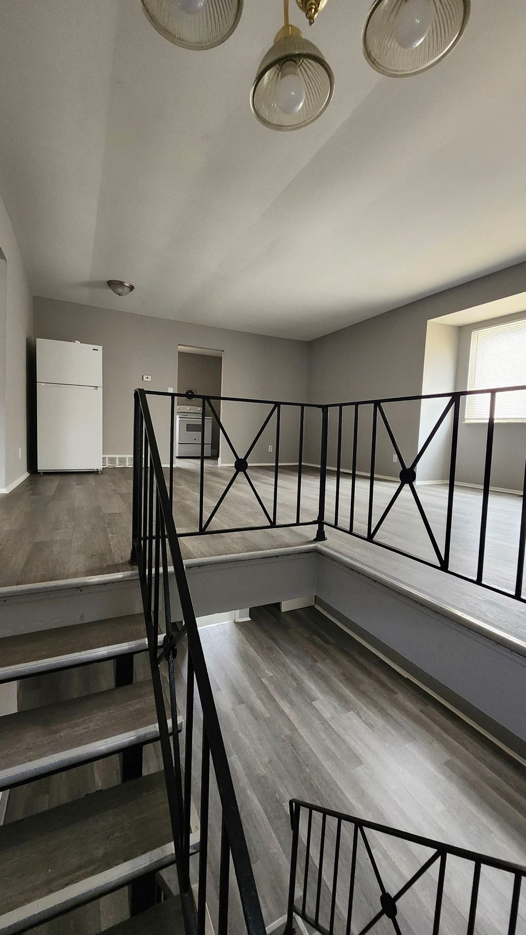A staircase with a black railing and wooden steps.