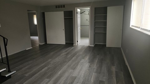 A room with a wooden floor and a white door.