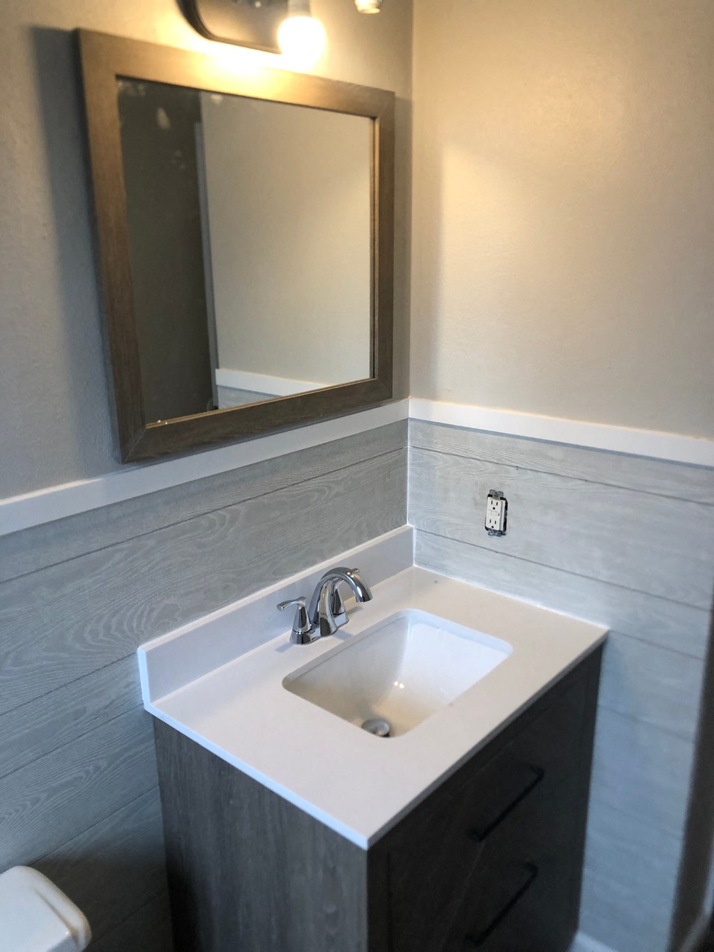 a small bathroom with a sink and a mirror
