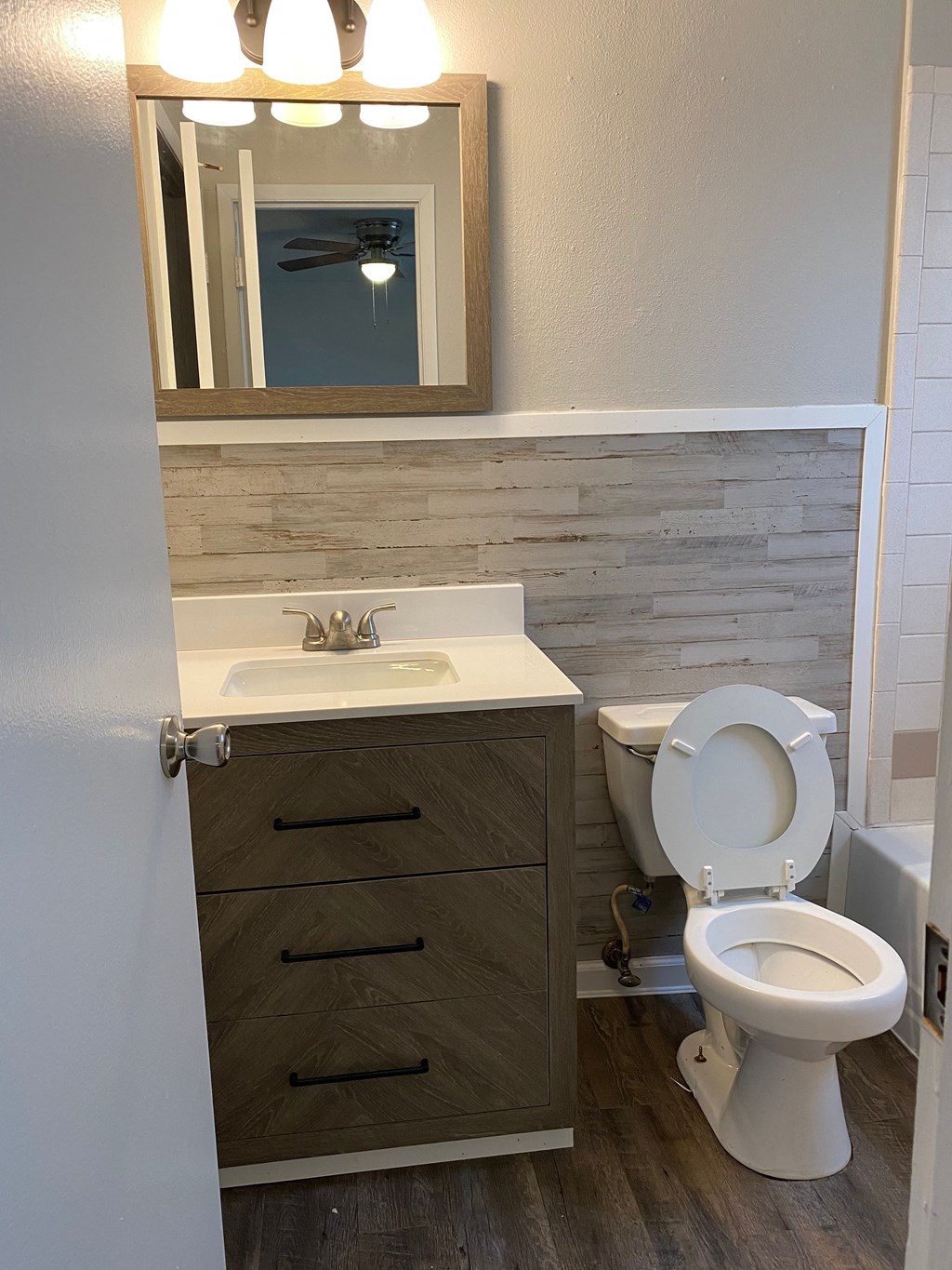 a bathroom with a toilet and a sink and a mirror