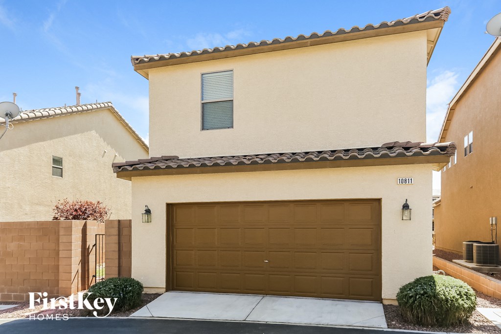 a house with a garage door in front of it
