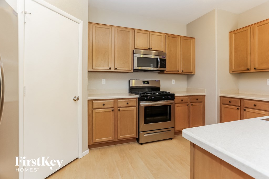 a kitchen with wooden cabinets and stainless steel appliances