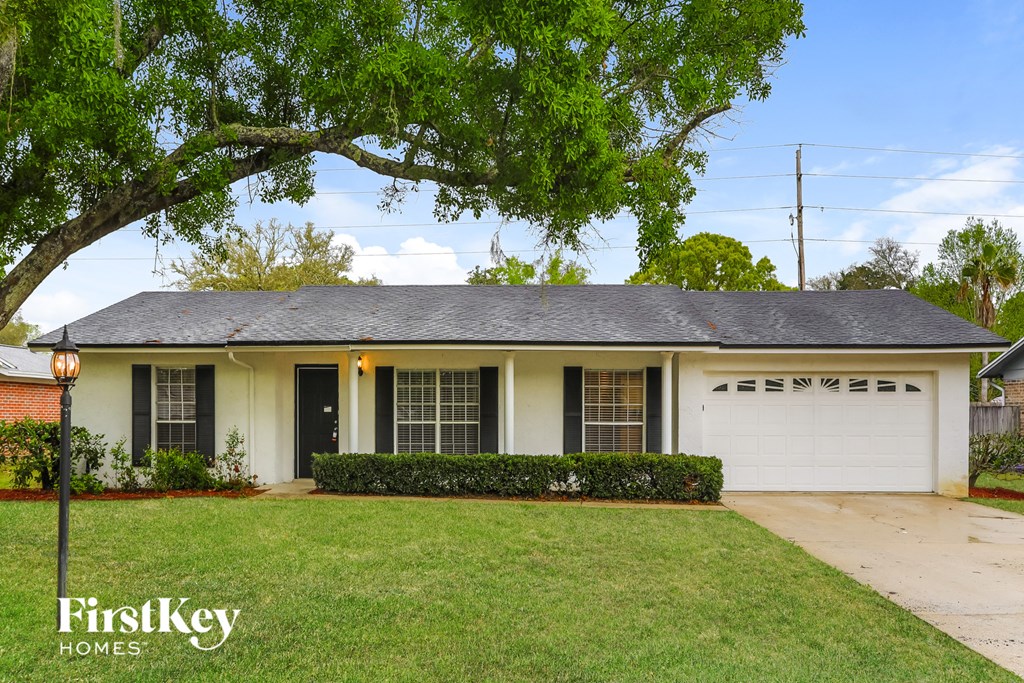 A house with a white garage door is for sale.