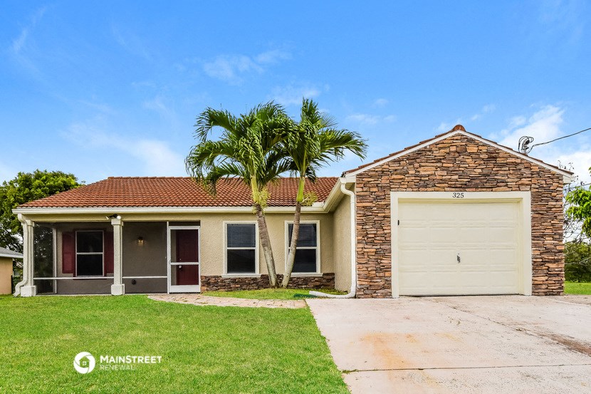 a house with a palm tree in front of it