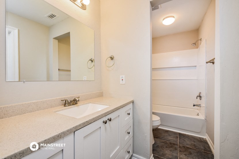 a bathroom with a sink and a toilet and a shower