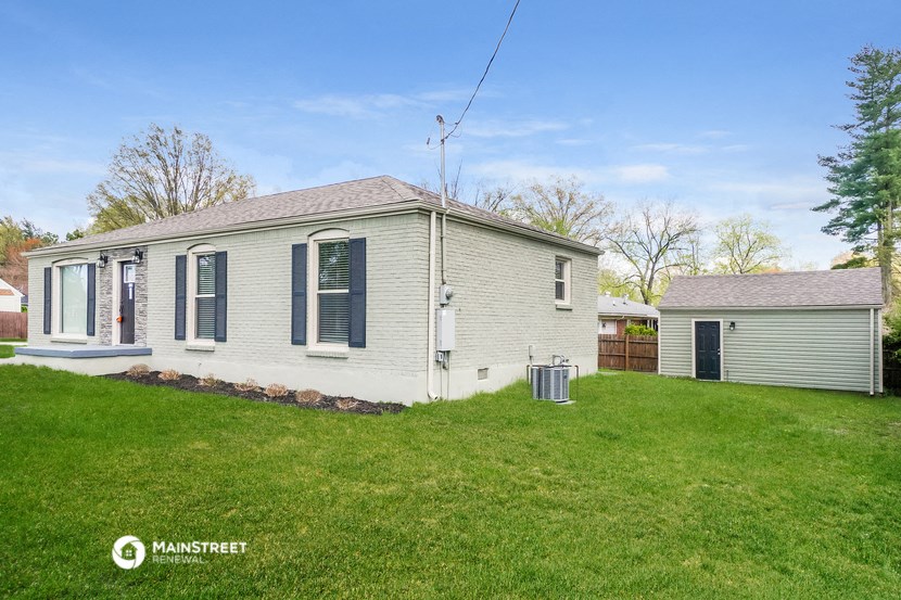 a white house with a yard in front of it