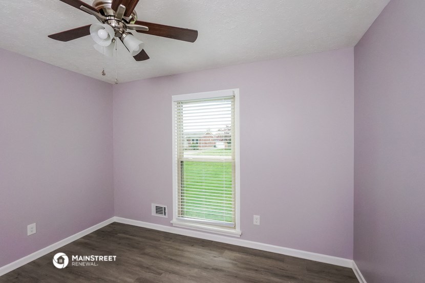 a room with a ceiling fan and a window
