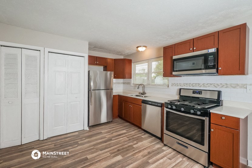 a kitchen with stainless steel appliances and wooden cabinets