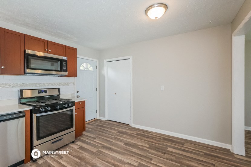 the kitchen of our studio apartment atrium with stove and microwave