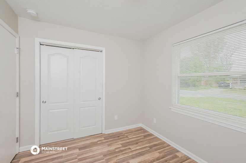 the interior of an empty room with a door and a window