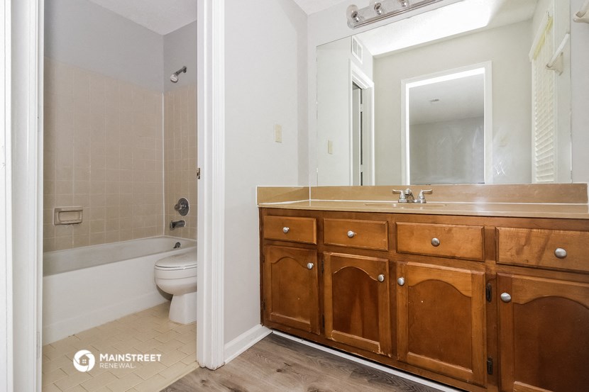 a bathroom with a sink and a toilet and a mirror