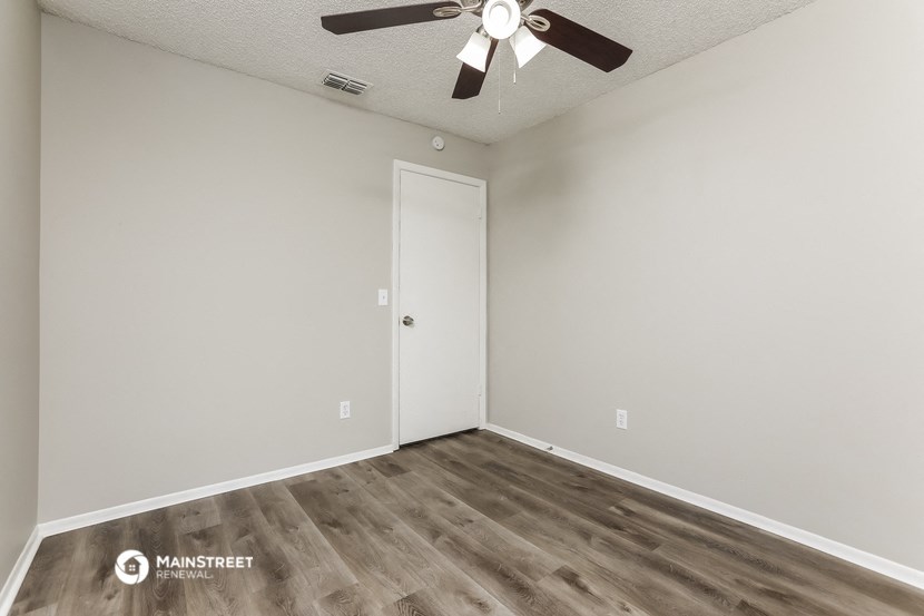 the living room of our studio apartment atrium with a ceiling fan