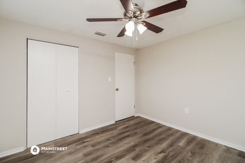 the bedroom of our studio apartment atrium with closet and ceiling fan