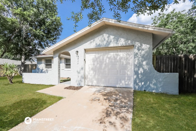a small white house with a white garage door