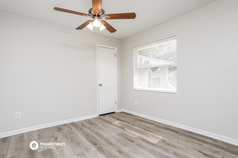 the living room of our studio apartment atrium with a ceiling fan