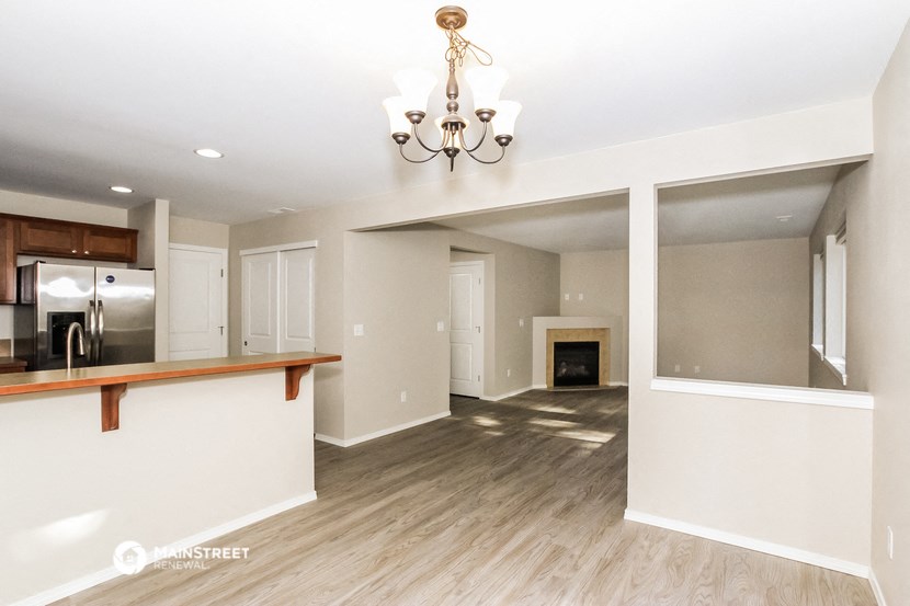 an open kitchen and living room with a fireplace