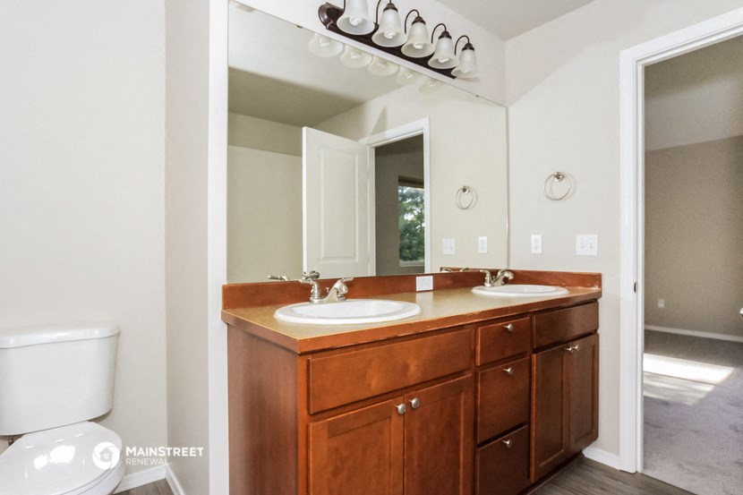 a bathroom with two sinks and a large mirror