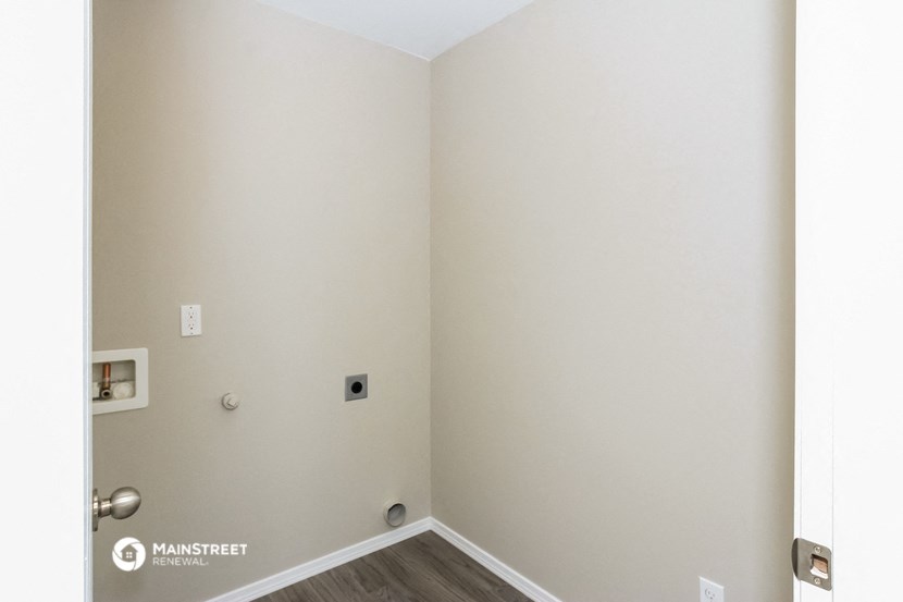 an empty room with white walls and a door