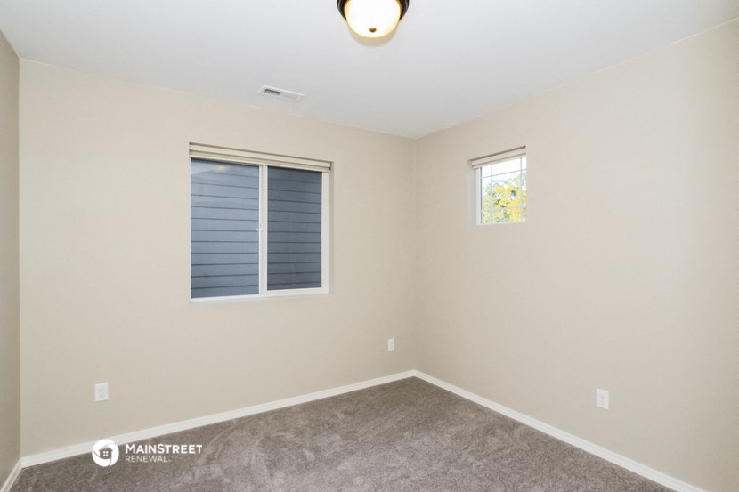 the interior of a small room with carpet and a window