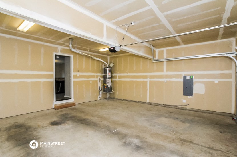 the interior of a garage with yellow walls and a fireplace